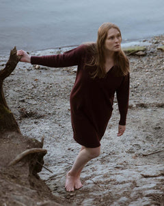 Model on beach wearing the Hekla Knitted Dress. Model is size 180 cm tall and wearing a size L